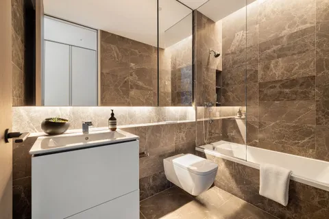 a bathroom with a sink mirror vanity and toilet