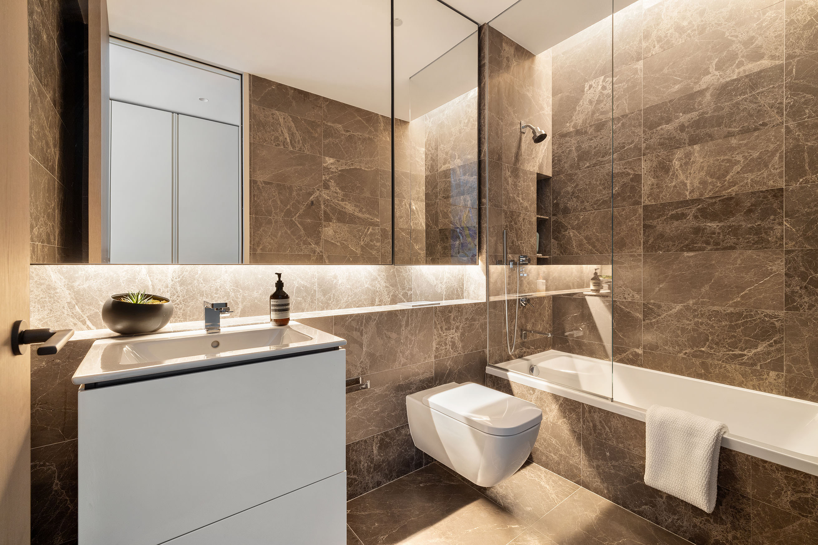 515 West 29th Street, Unit 2S Manhattan, NY 10001 - Photo 8 of 11 a bathroom with a sink mirror vanity and toilet