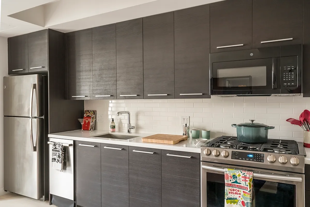 a kitchen with stainless steel appliances granite countertop a stove a refrigerator and a sink