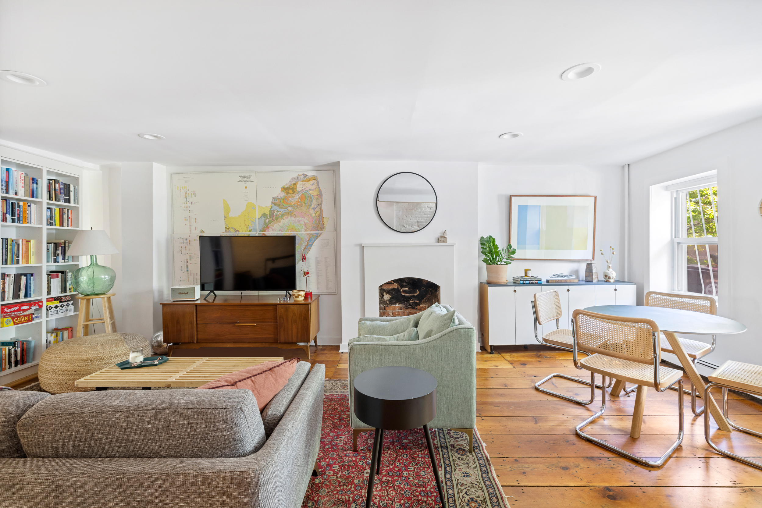 437 Warren Street Brooklyn, NY 11217 - Photo 2 of 17 a living room with furniture a flat screen tv and a fireplace