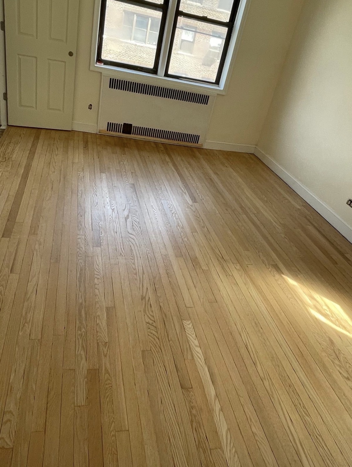 69-40 Yellowstone Boulevard, Unit 510 Queens, NY 11375 - Photo 9 of 11 a view of an empty room and wooden floor
