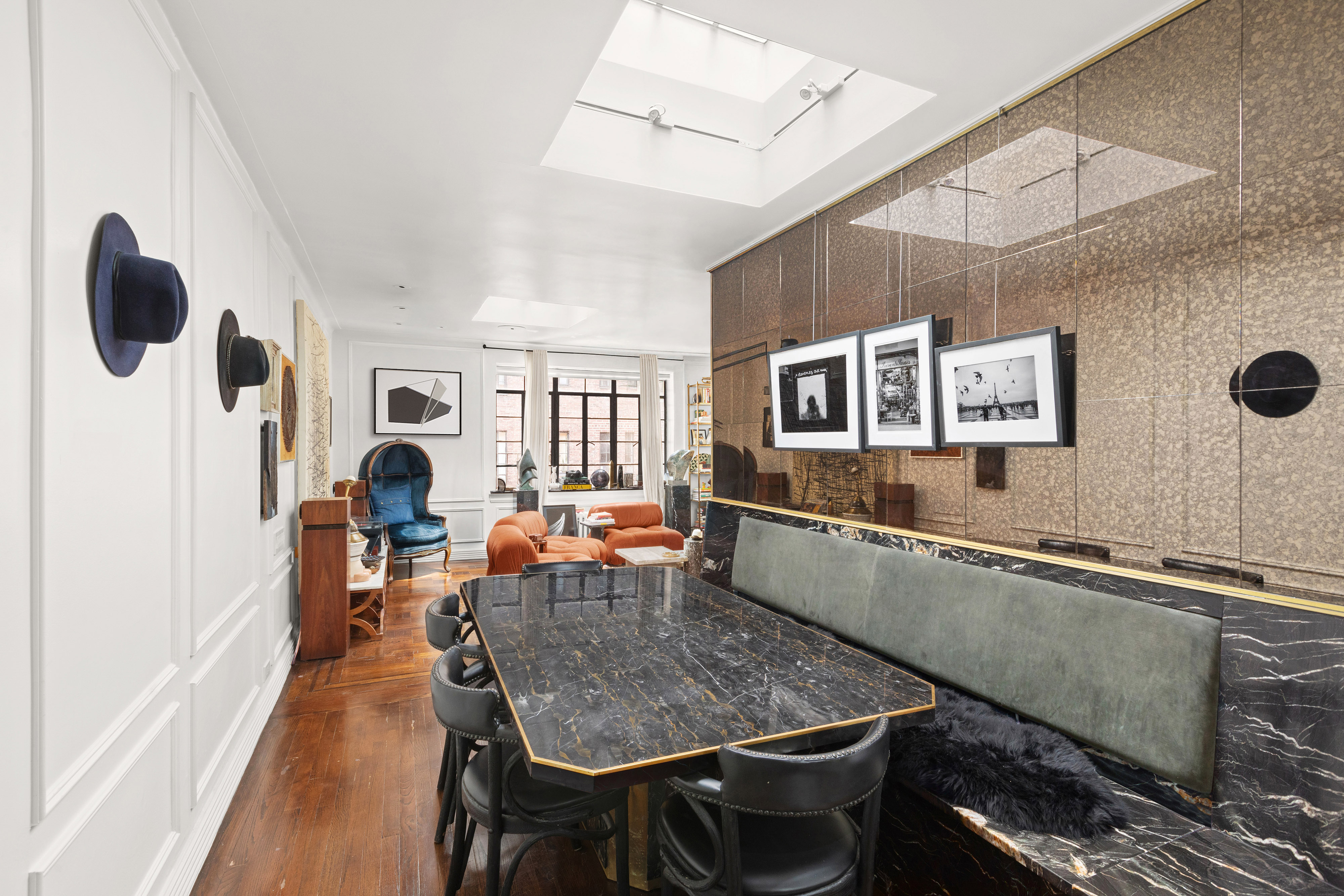 135 East 39th Street, Unit 6D Manhattan, NY 10016 - Photo 4 of 11 a dining room with stainless steel appliances kitchen island granite countertop a table chairs in it and a wooden floor