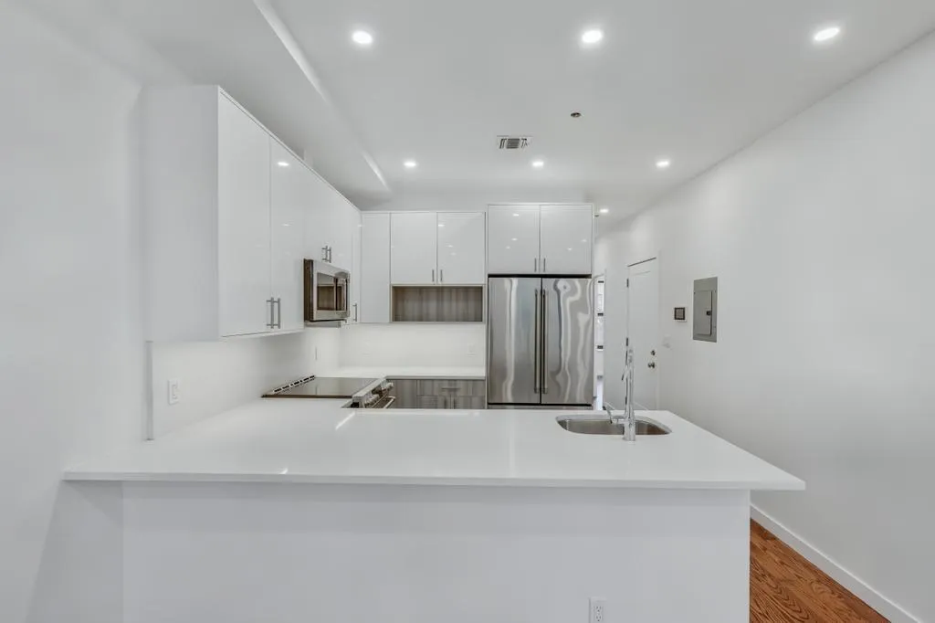 a bathroom with a sink a mirror and shower