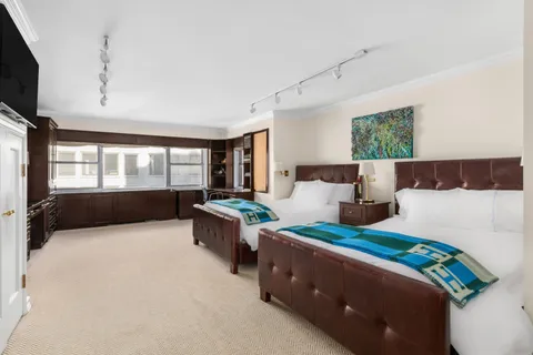 a bedroom with a bed and large window