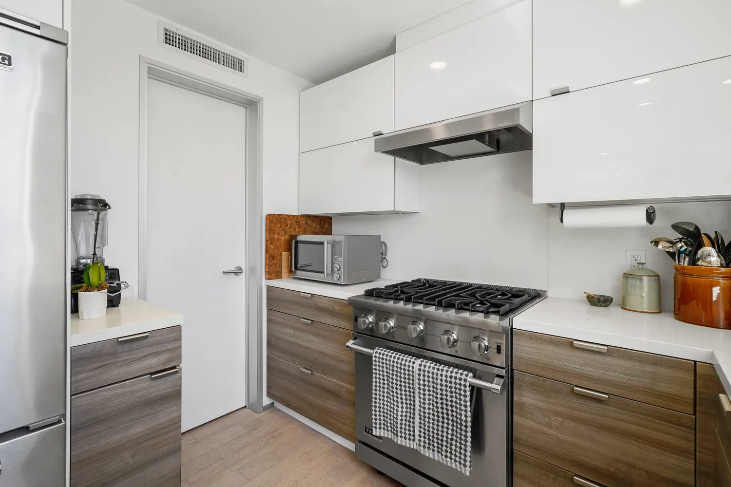 a kitchen with stainless steel appliances granite countertop a stove and a refrigerator