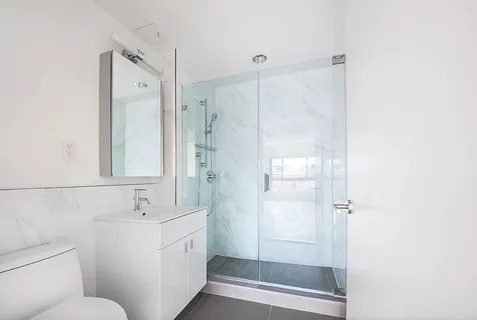 a bathroom with a shower sink and toilet