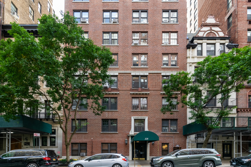 328 West 86th Street, Unit 6A Manhattan, NY 10024 - Photo 9 of 10 a front view of a building with lot of cars and trees