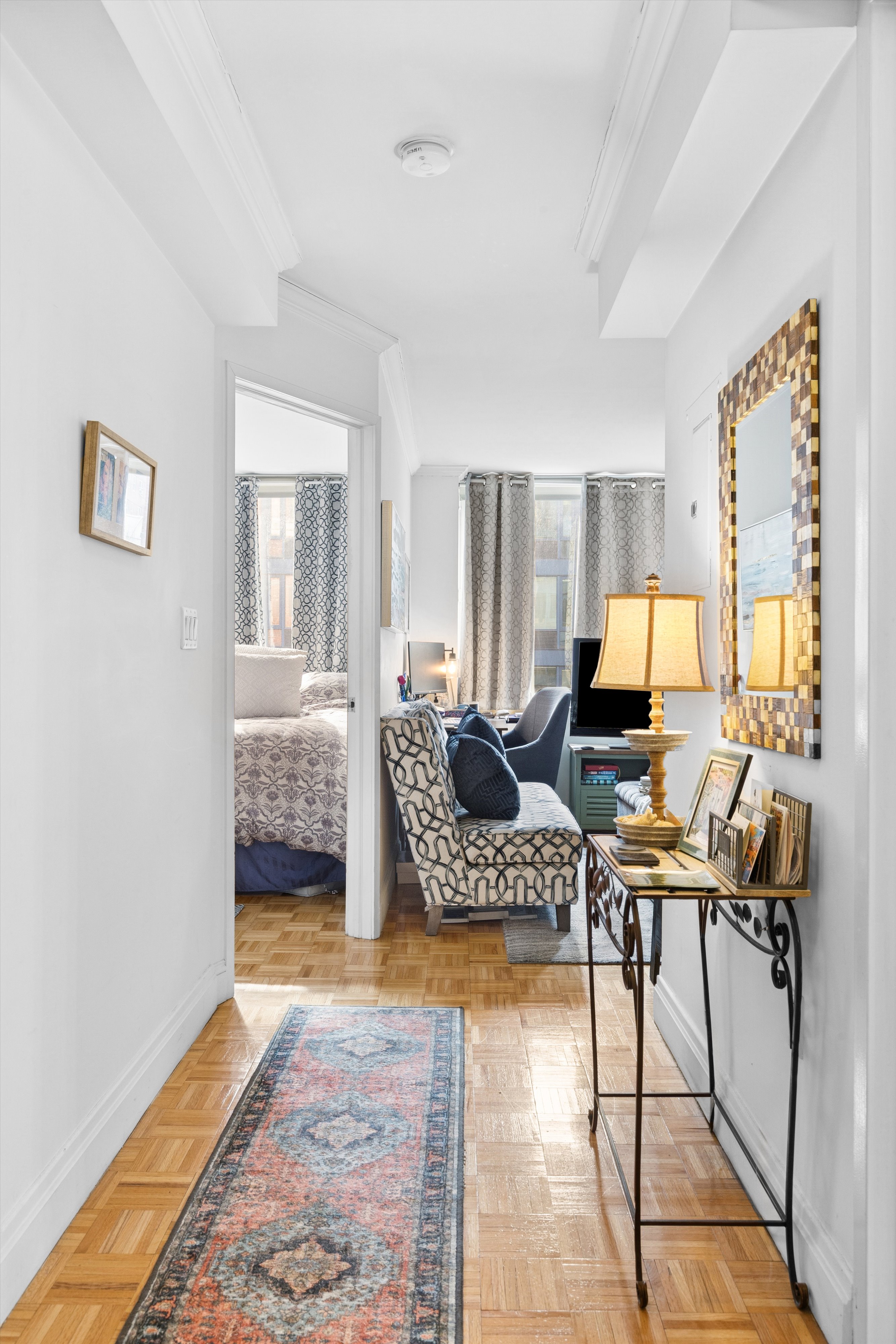 404 East 76th Street, Unit 4M Manhattan, NY 10021 - Photo 4 of 13 a workspace with furniture and a window