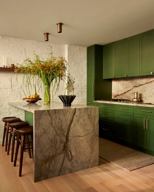 a living room with furniture and a kitchen view