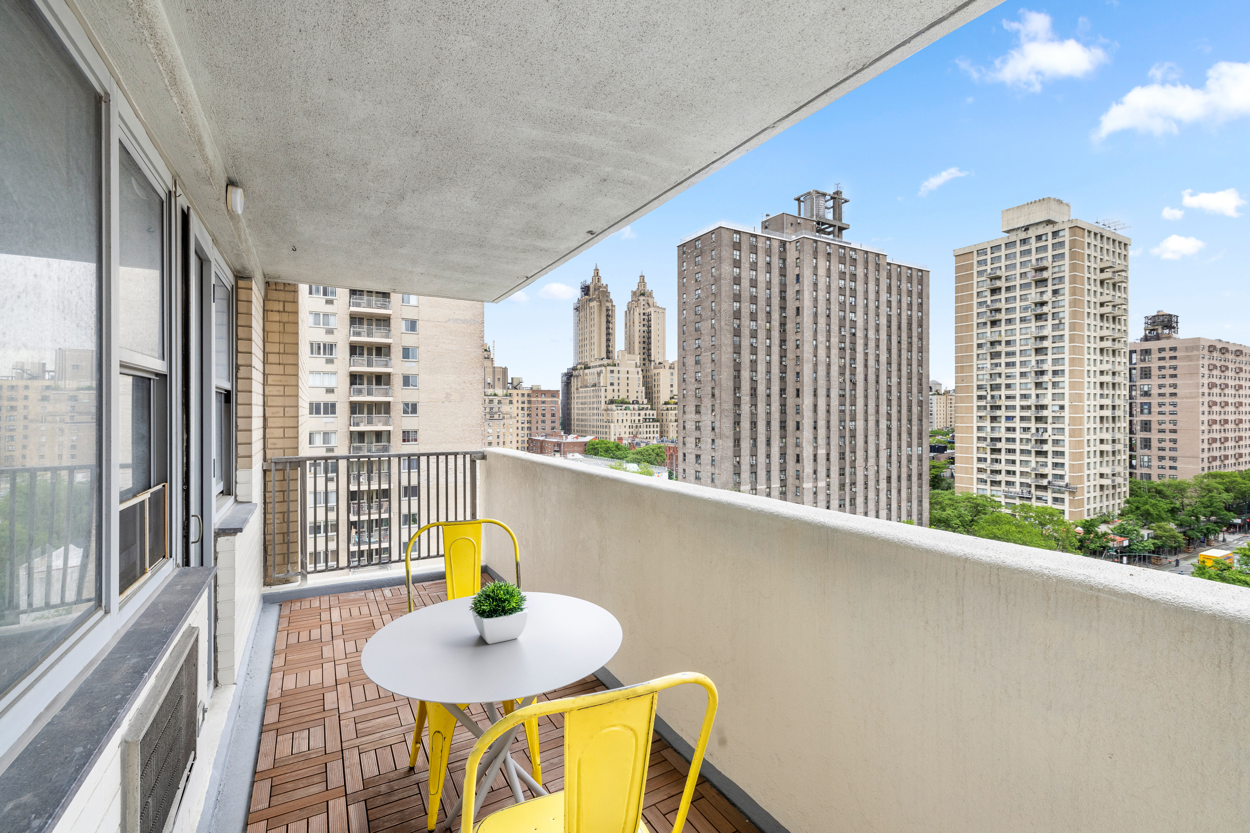 100 West 93rd Street, Unit 11J Manhattan, NY 10025 - Photo 7 of 13 a dining room with furniture and a floor to ceiling window