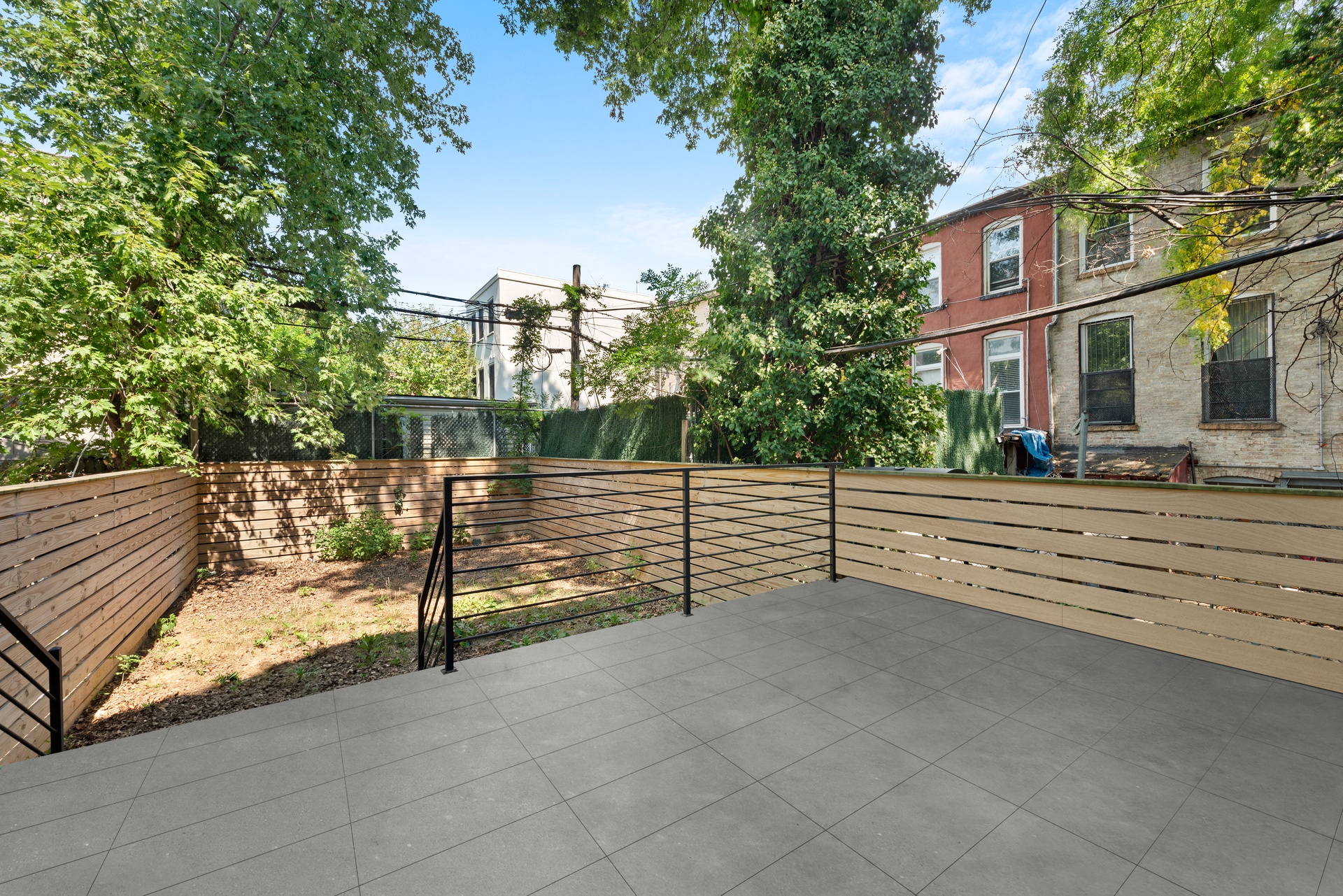65 Bainbridge Street Brooklyn, NY 11233 - Photo 6 of 24 a view of a street with wooden fence
