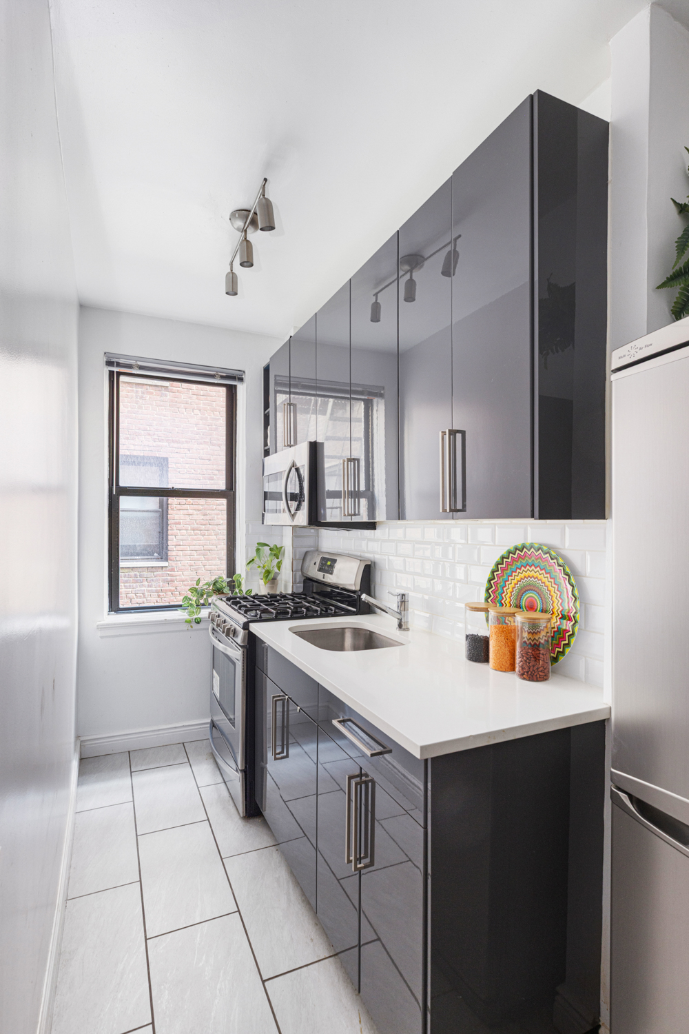 160 West 85th Street, Unit 3F Manhattan, NY 10024 - Photo 5 of 10 a kitchen with a sink a stove and cabinets