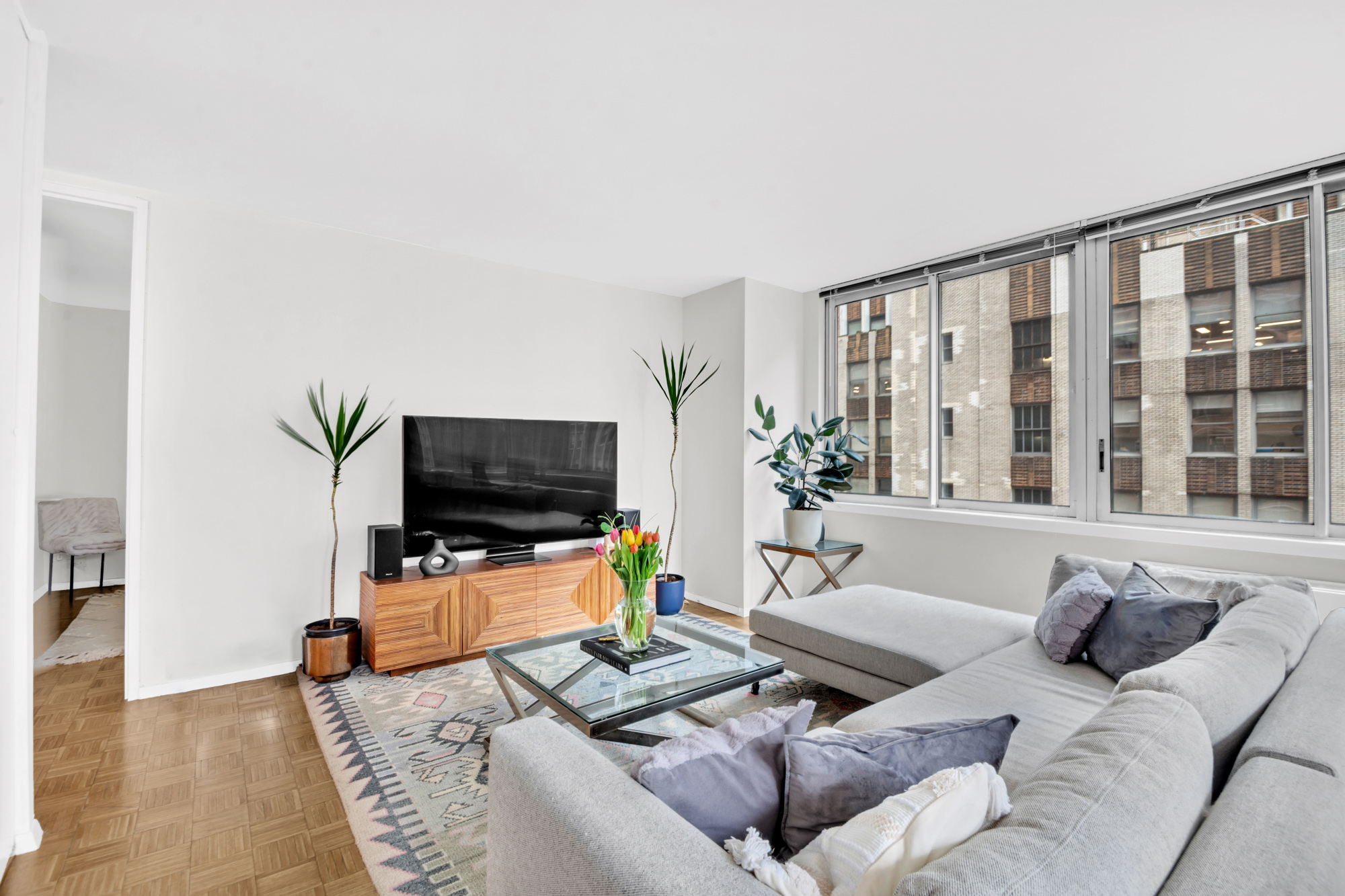 235 East 40th Street, Unit 11G Manhattan, NY 10016 - Photo 5 of 20 a living room with furniture and a flat screen tv