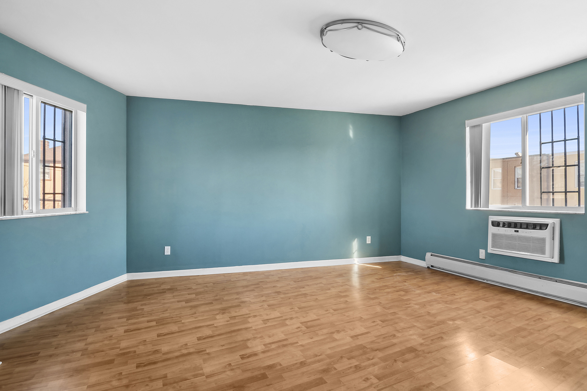 21-08 Butler Avenue, Unit J2 Queens, NY 11385 - Photo 10 of 14 a view of an empty room with a window