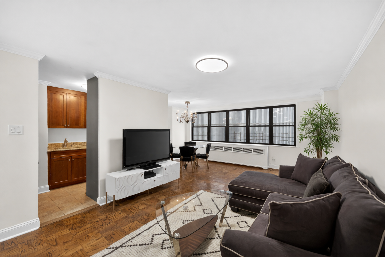 330 3rd Avenue, Unit 8A Manhattan, NY 10010 - Photo 1 of 13 a living room with furniture and a flat screen tv