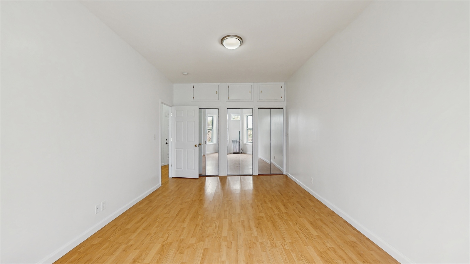 454 77th Street, Unit 3 Brooklyn, NY 11209 - Photo 20 of 25 a view of a big room with wooden floor and windows