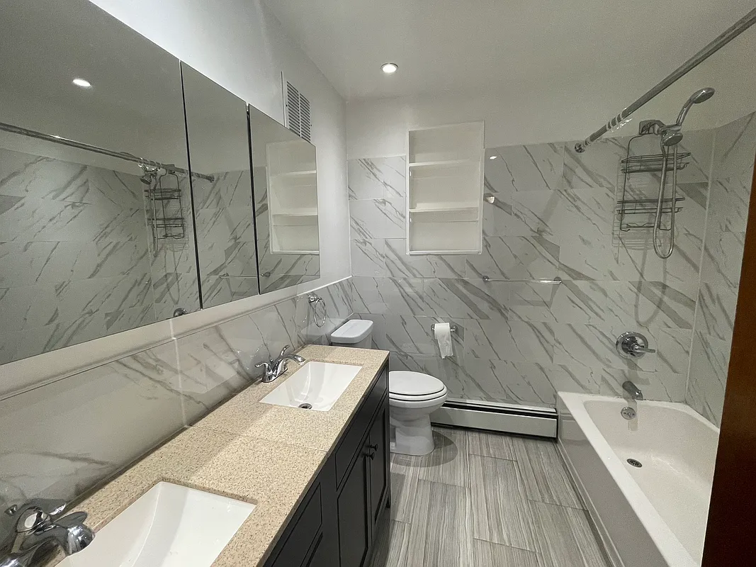 25-92 36th Street, Unit 2 Queens, NY 11103 - Photo 6 of 7 a bathroom with a sink a toilet and shower