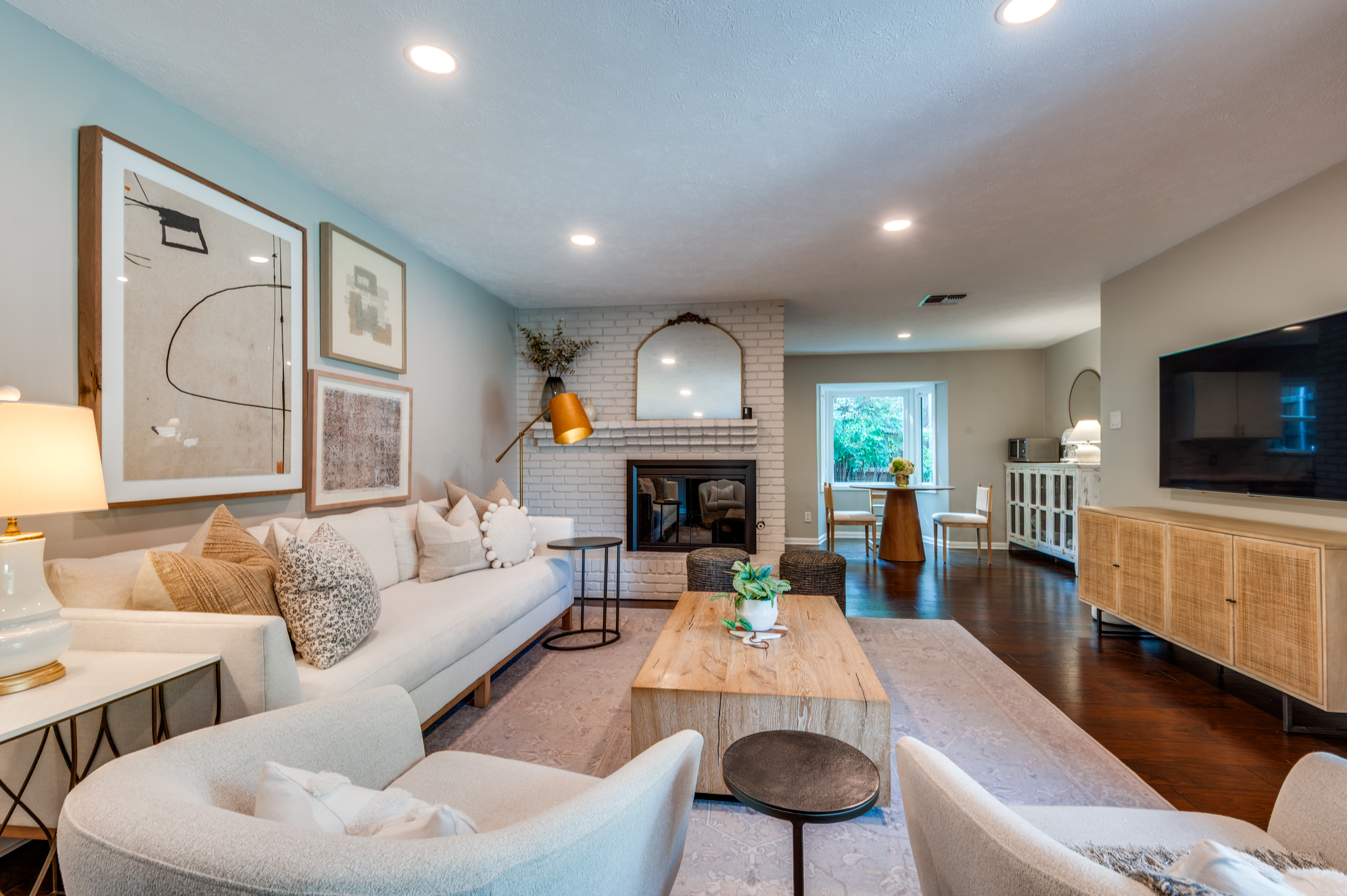 3363 Merrell Road Dallas, TX 75229 - Photo 6 of 29 a living room with furniture fireplace and a flat screen tv