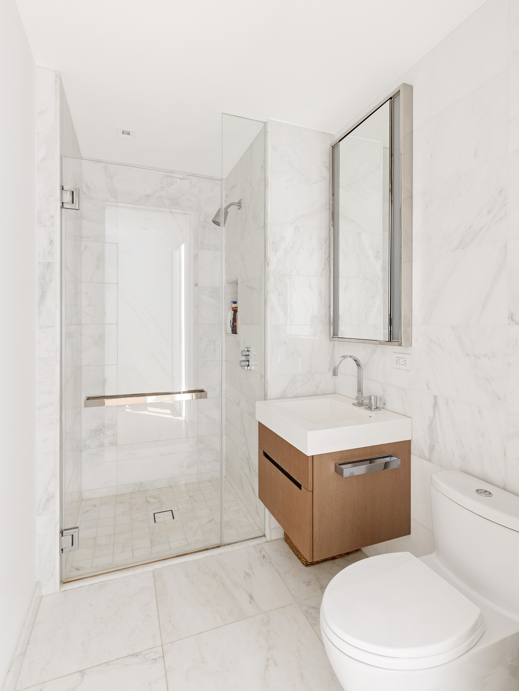 1 West End Avenue, Unit 12D Manhattan, NY 10023 - Photo 12 of 32 a bathroom with a toilet sink and shower