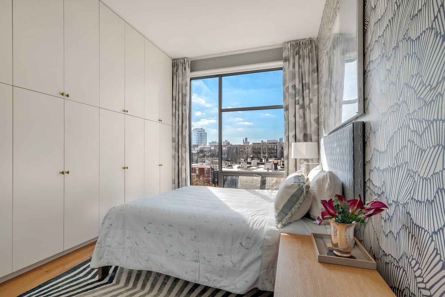 280 Metropolitan Avenue, Unit 5D Brooklyn, NY 11211 - Photo 8 of 22 a room with a bed and a potted plant