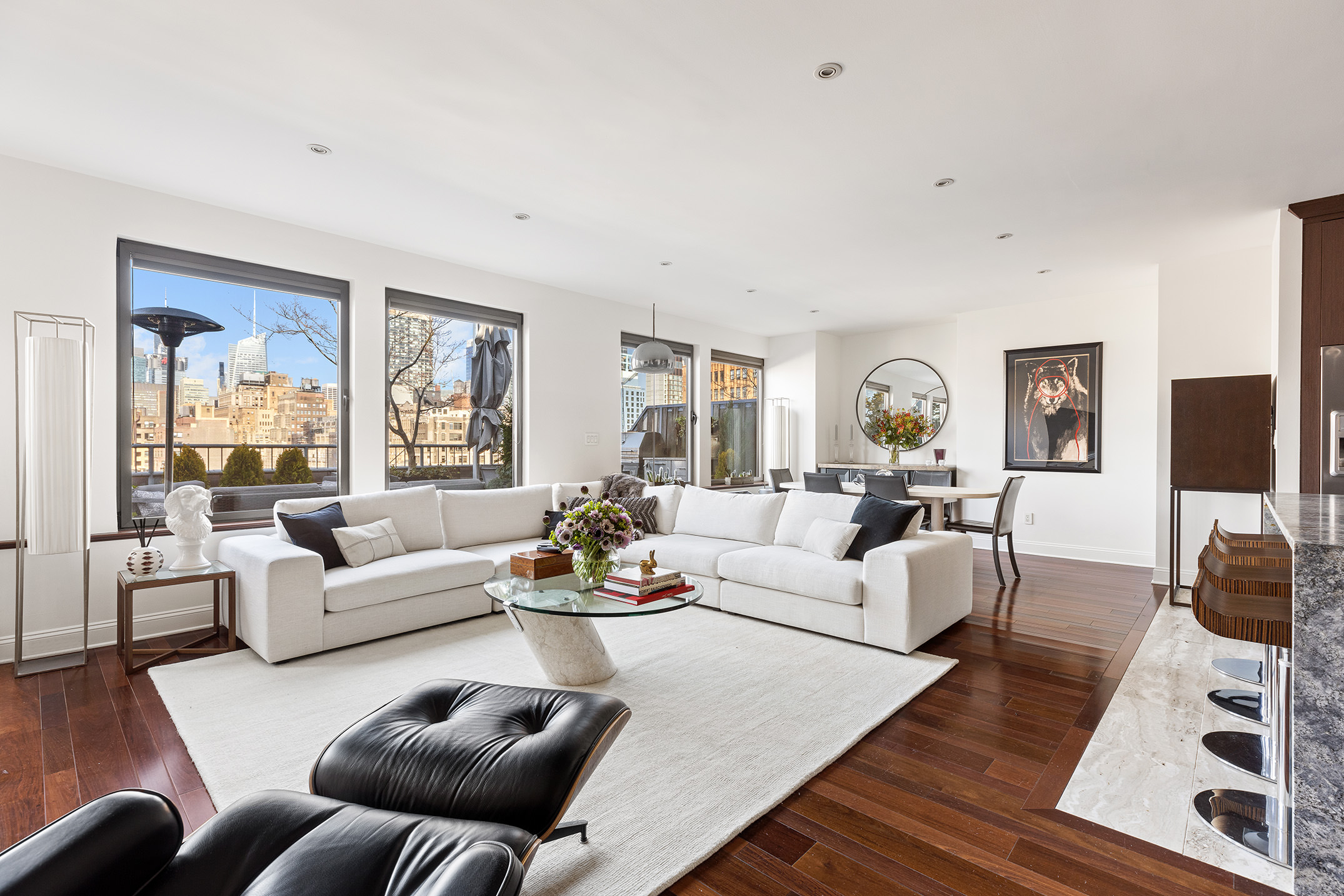 252 7th Avenue, Unit PHG Manhattan, NY 10001 - Photo 5 of 27 a living room with furniture flat screen tv and a large window