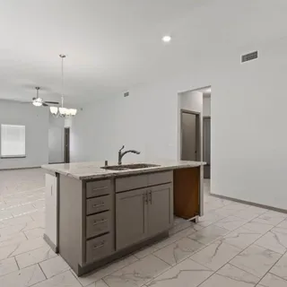 a spacious bathroom with a double vanity sink and a mirror