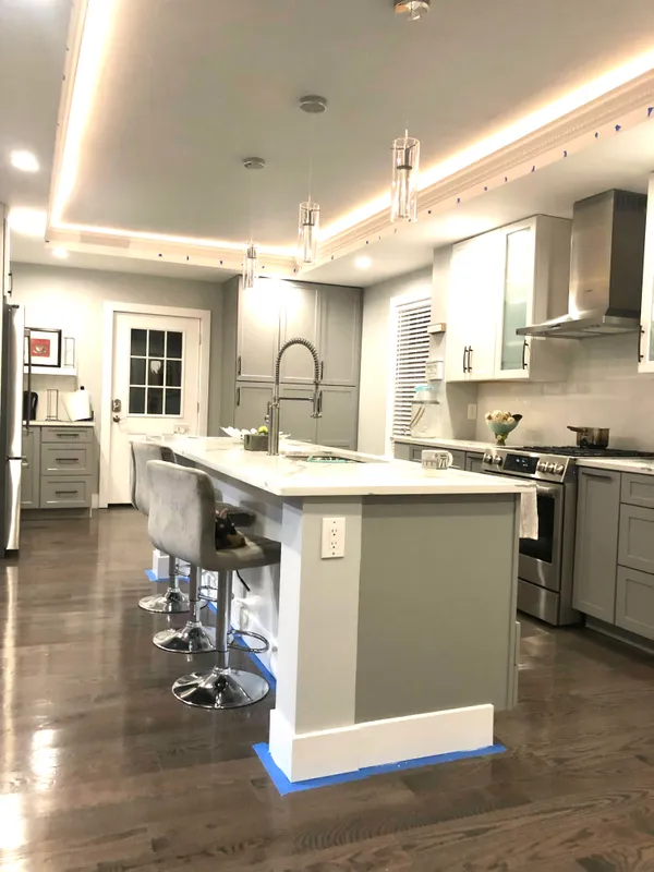 a kitchen with a sink cabinets and wooden floor