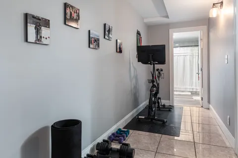 a view of a hallway with workspace and a window