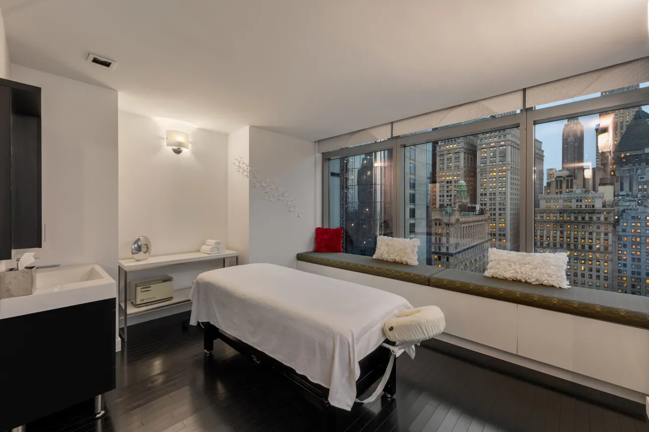 a bedroom with a bed and a large window