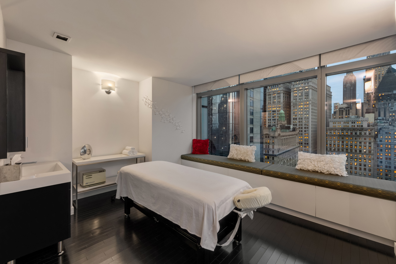 123 Washington Street, Unit 30F Manhattan, NY 10006 - Photo 9 of 11 a bedroom with a bed and a large window