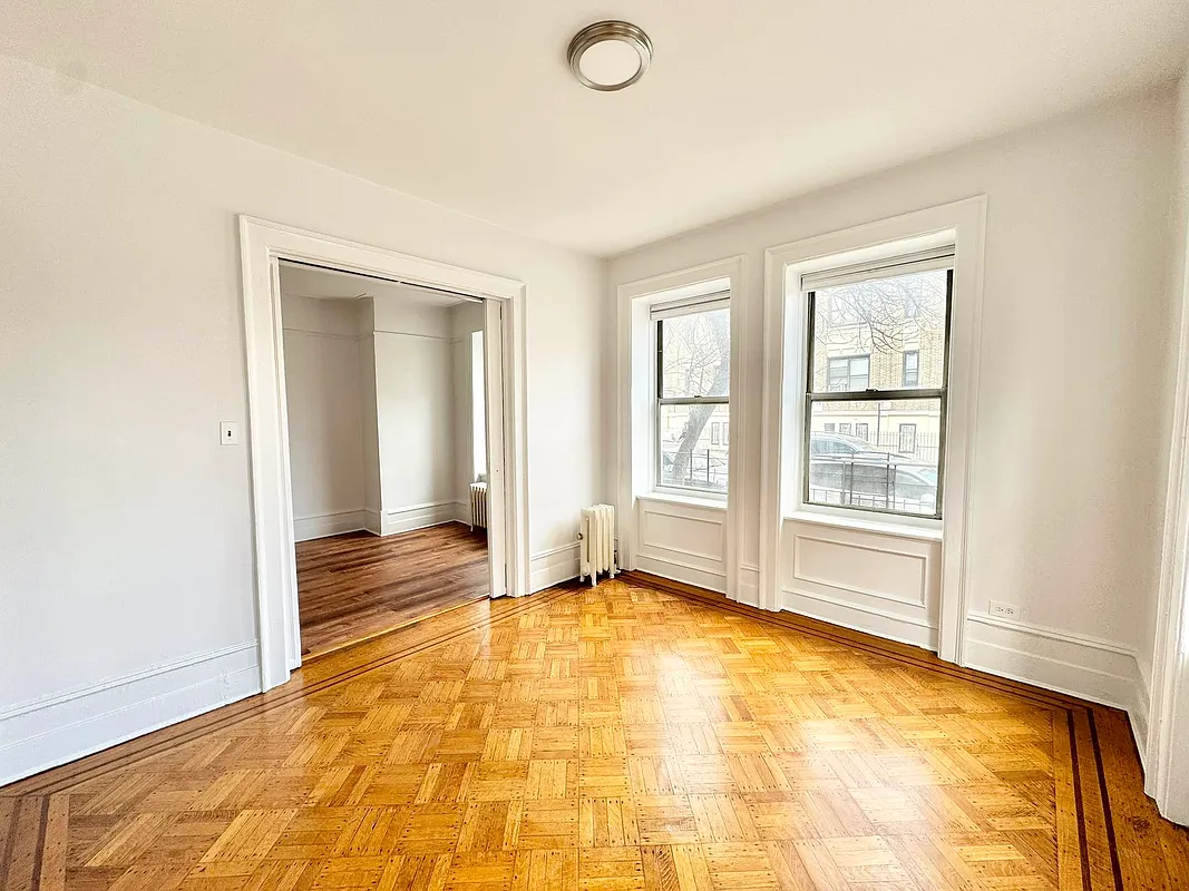 2022 Beverley Road, Unit 3 Brooklyn, NY 11226 - Photo 4 of 11 a view of an empty room with window and a bathroom