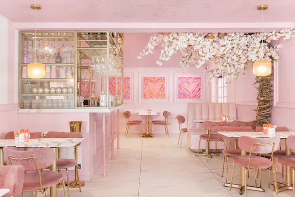 a dining room with furniture and a large window