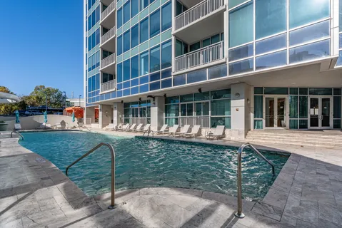 a backyard of a house with lots of green space and seating