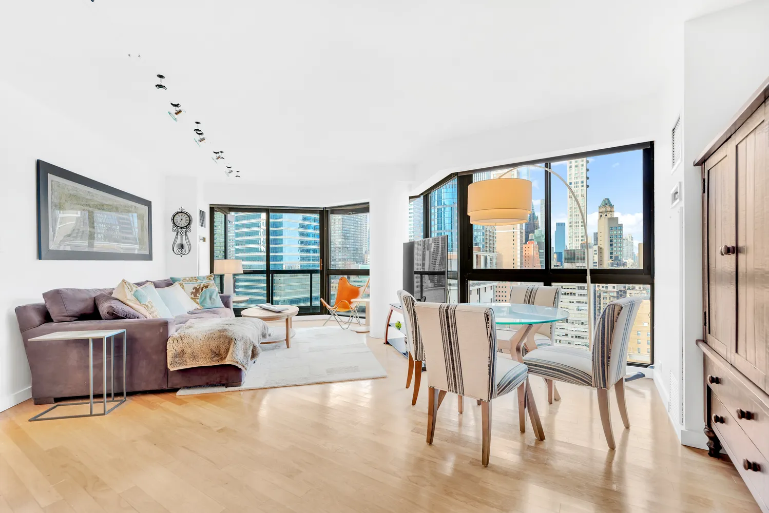 a living room with furniture and large windows