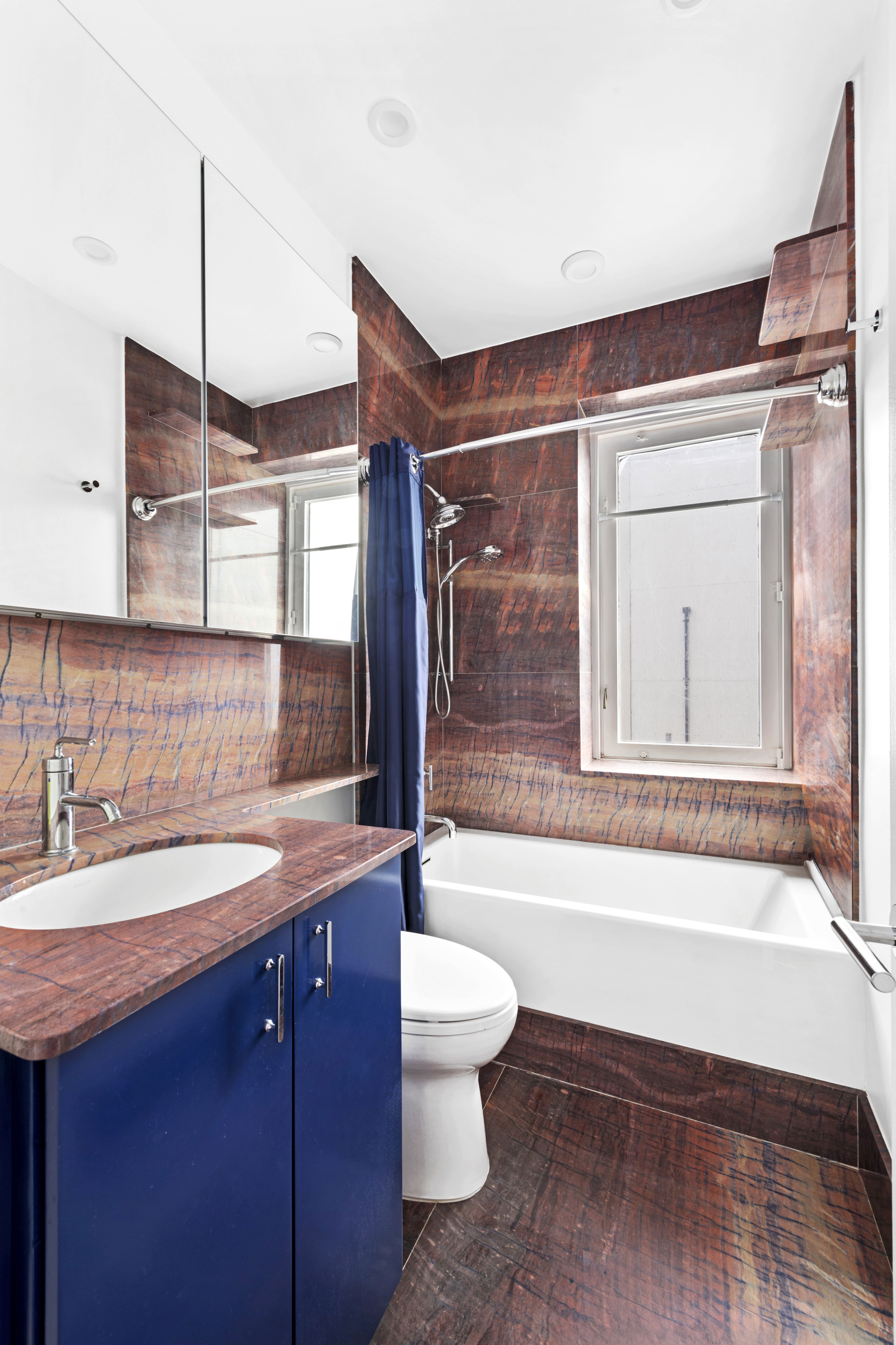 524 East 72nd Street, Unit 26A Manhattan, NY 10021 - Photo 8 of 16 a bathroom with a sink a toilet and shower