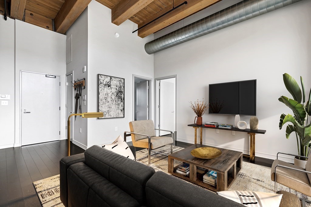 319 A Street, Unit 211 Boston, MA 02210 - Photo 8 of 24 a living room with furniture and a flat screen tv