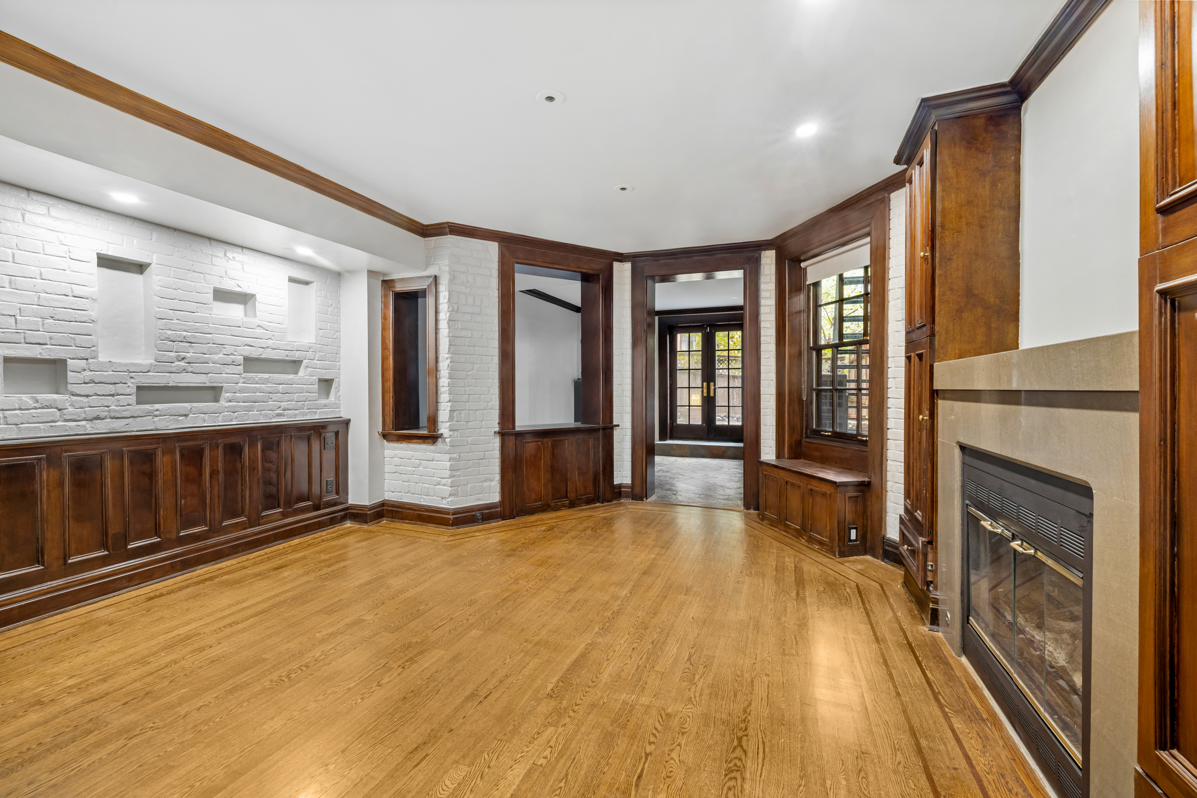 29 East 126th Street, Unit A Manhattan, NY 10035 - Photo 8 of 13 a view of an empty room with window and fire place