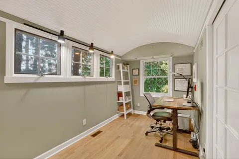 a bedroom with a bed and large window