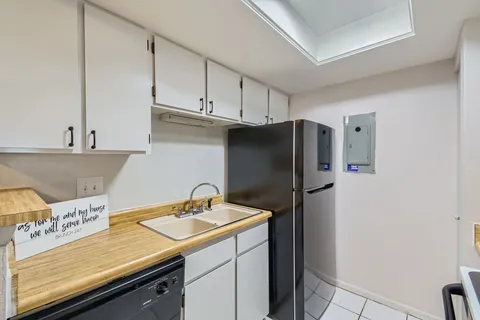 a kitchen with a sink cabinets and appliances