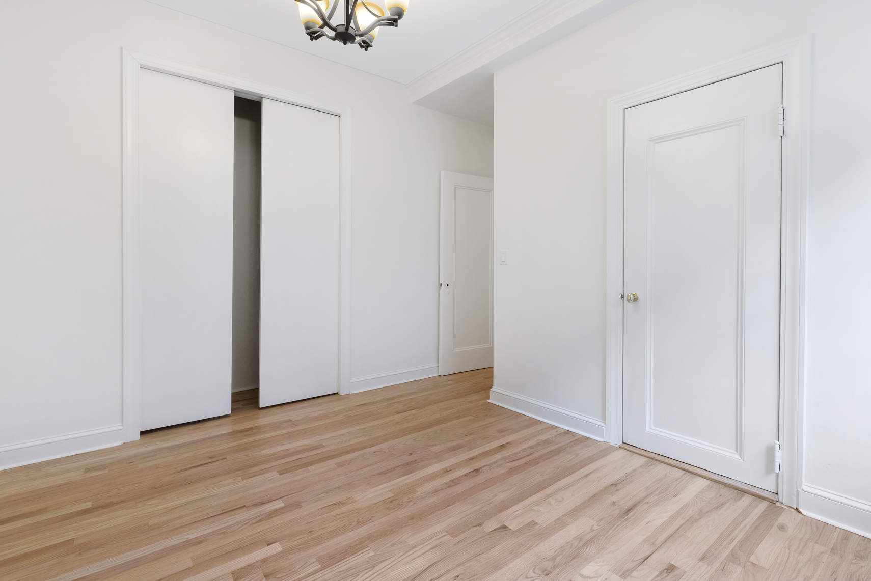 504-510 West 110th Street, Unit 5D Manhattan, NY 10025 - Photo 5 of 7 a view of an empty room with wooden floor