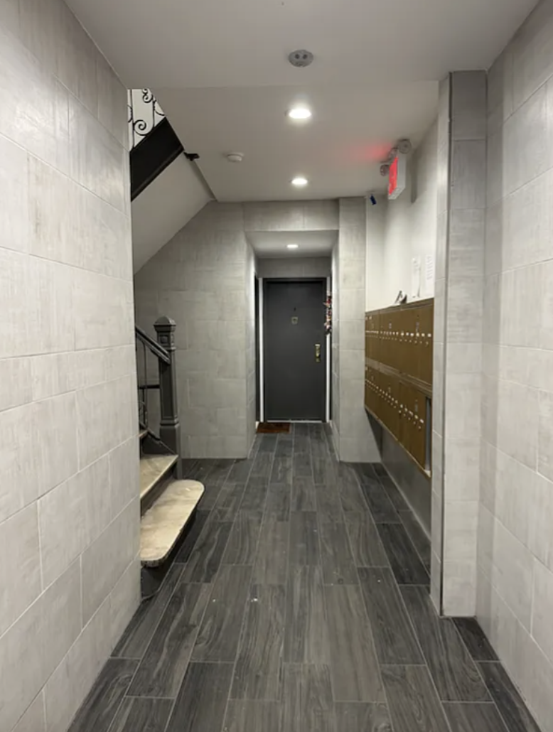 451 West 44th Street, Unit 63 Manhattan, NY 10036 - Photo 17 of 31 a view of a hallway with wooden floor and staircase