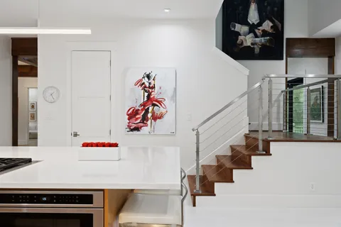a kitchen with a table chairs sink and cabinets