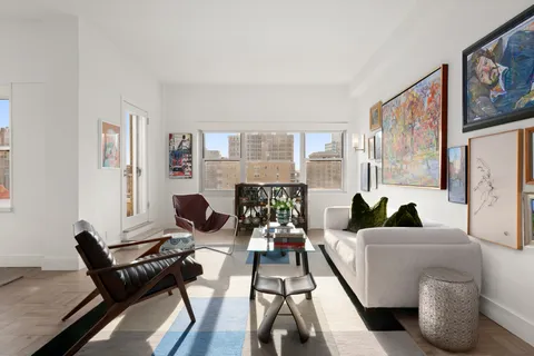 a living room with furniture and a floor to ceiling window