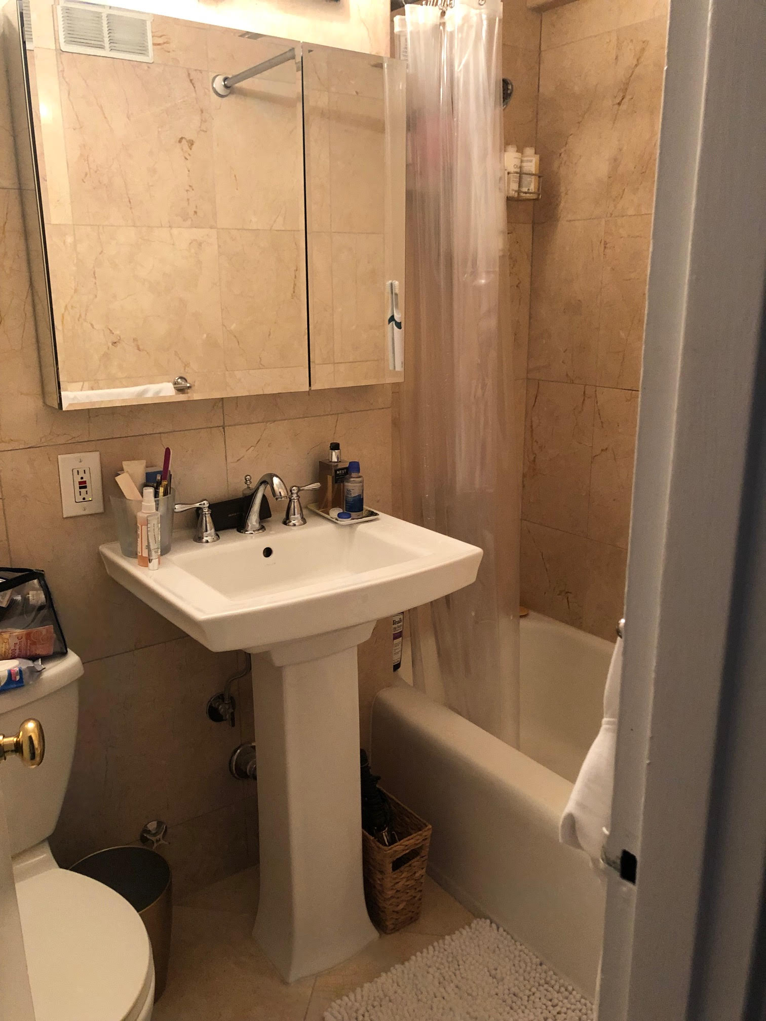 510 East 85th Street, Unit 11A6 Manhattan, NY 10028 - Photo 5 of 8 a bathroom with a sink a toilet and shower