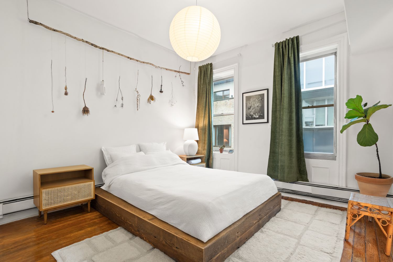 a bedroom with a bed and a potted plant