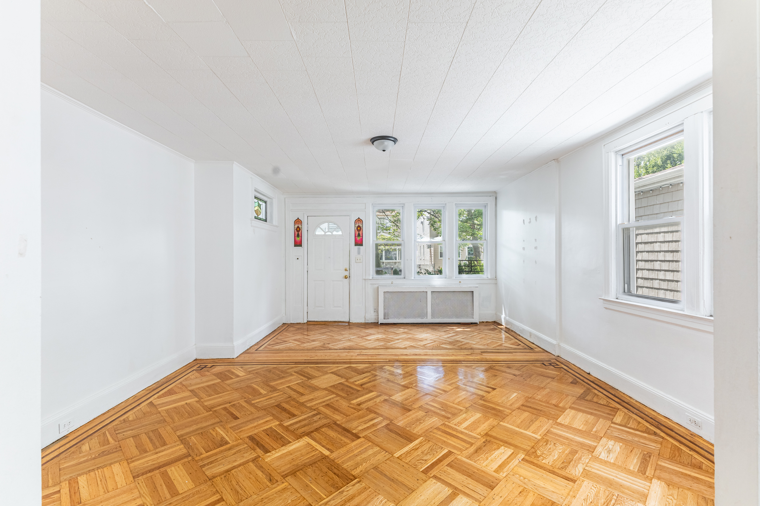69-29 67th Place Queens, NY 11385 - Photo 4 of 24 a view of an empty room and window