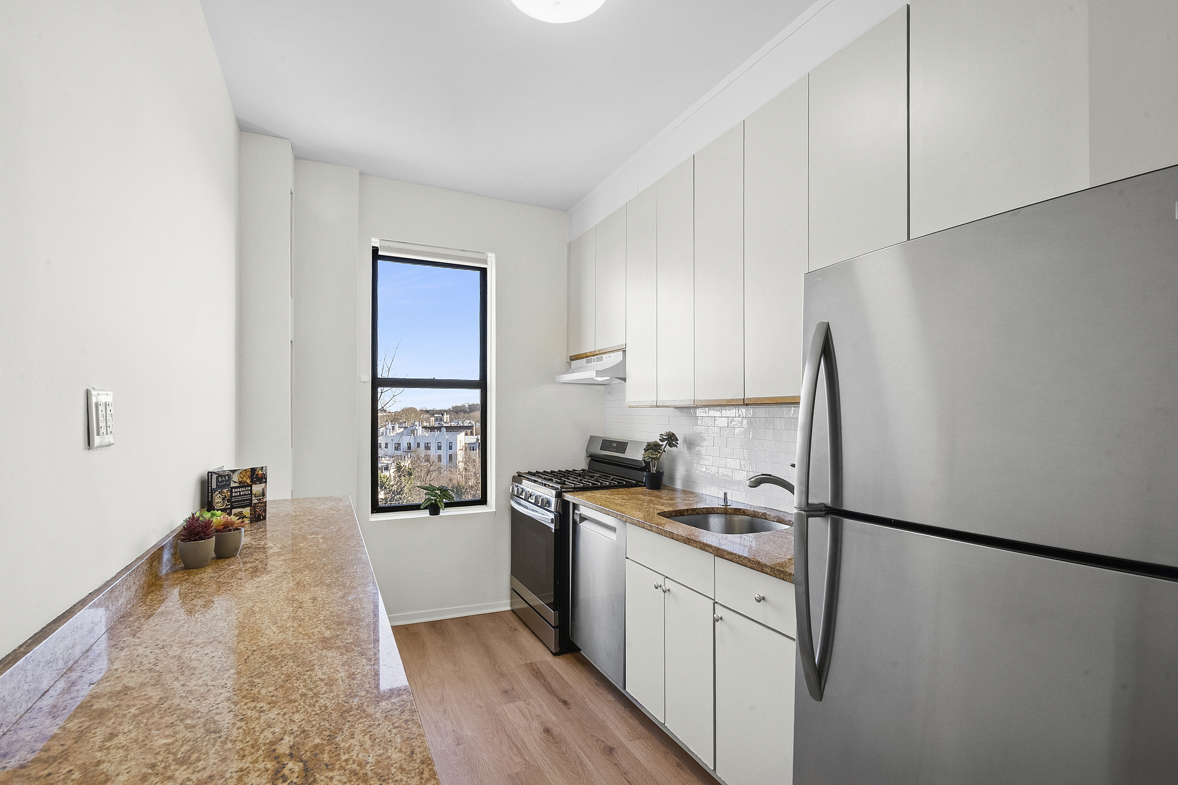 7401 4th Avenue, Unit F8 Brooklyn, NY 11209 - Photo 2 of 5 a kitchen with a refrigerator a sink and a stove