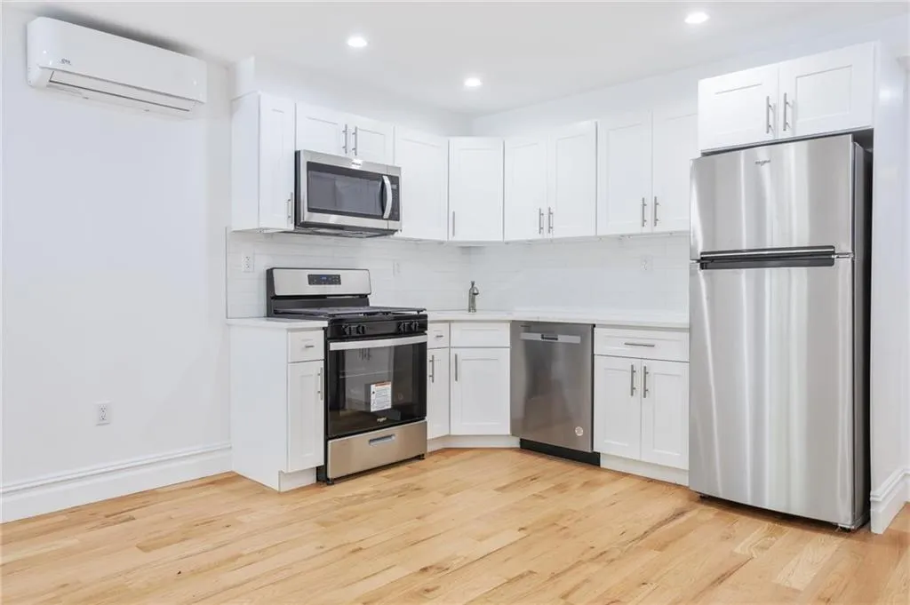 a kitchen with stainless steel appliances a refrigerator sink and microwave