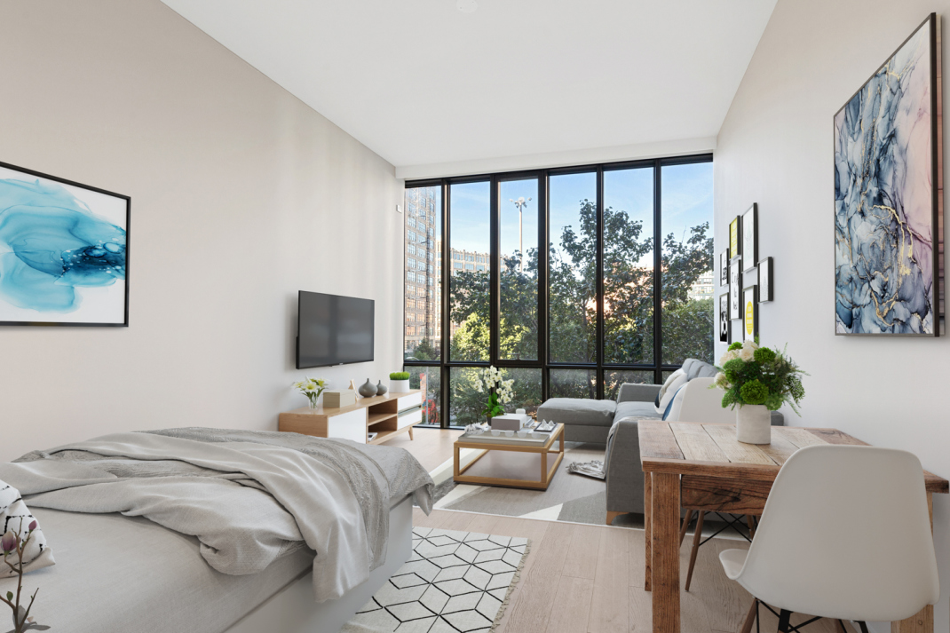 a bedroom with a bed and glass window