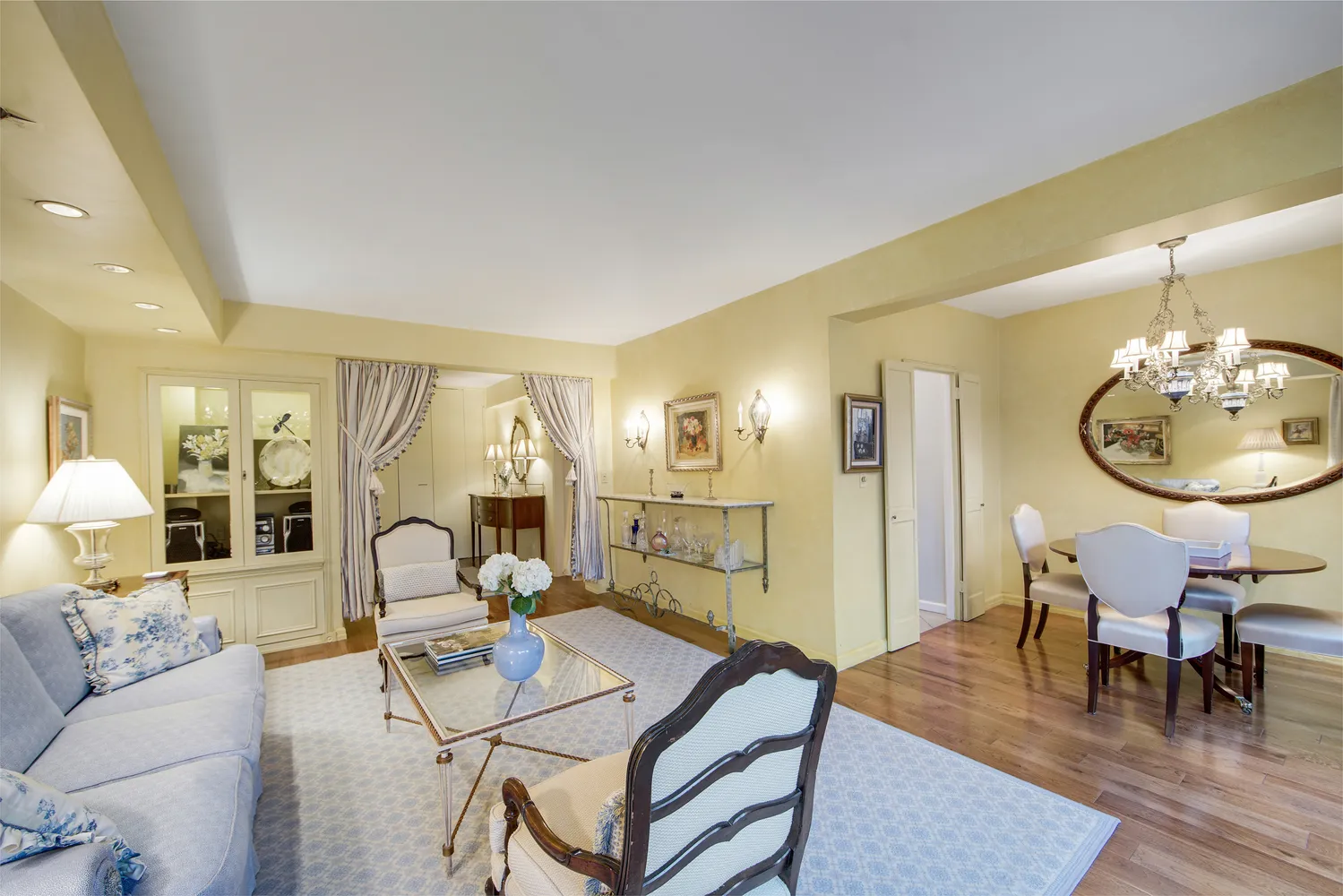 a living room with furniture a table and wooden floor